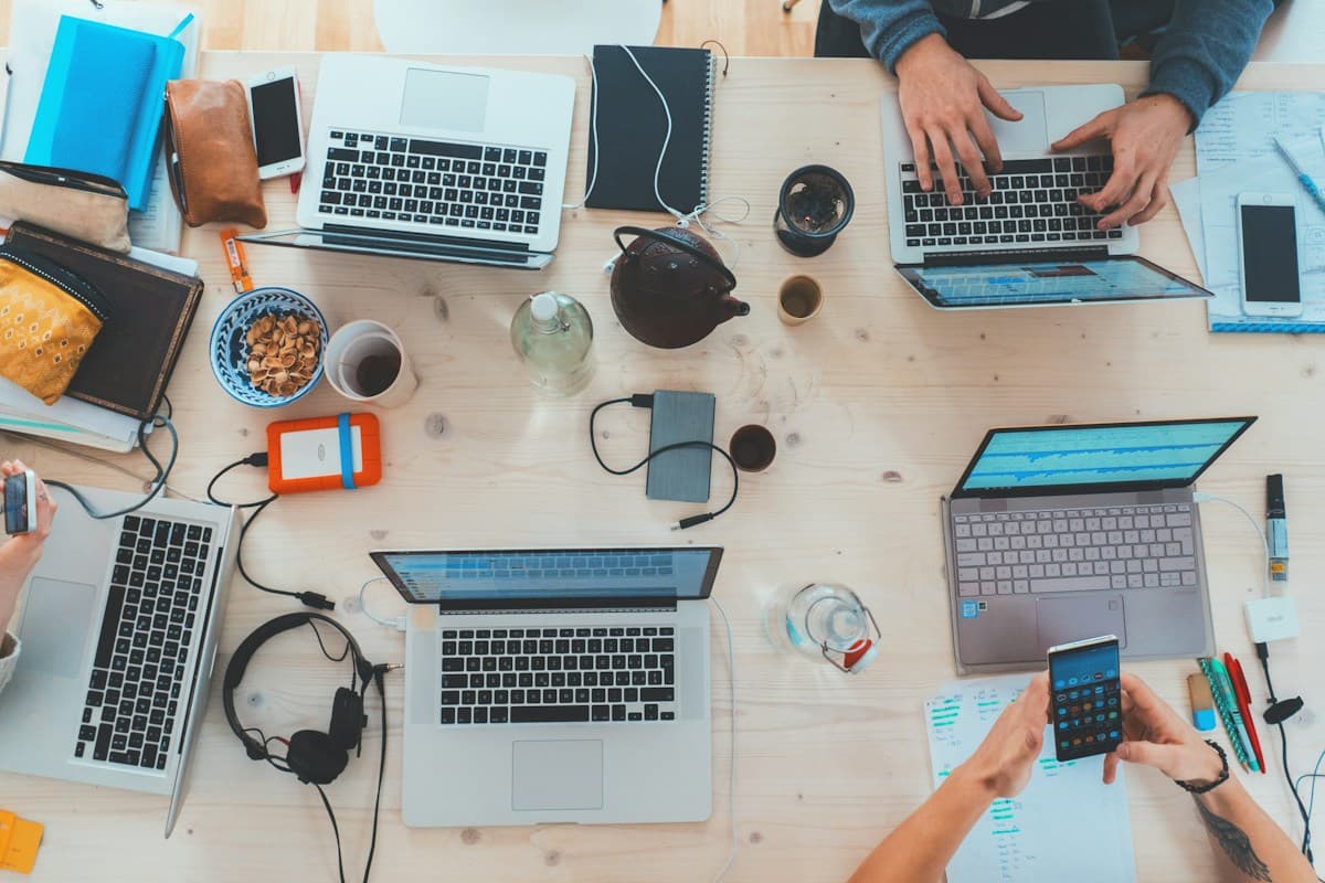 Illustrative shared workspace with laptops and notebooks